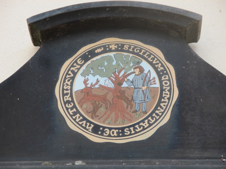 The seventeenth century Huntingdon Borough Seal.  Showing a hunter and his dogs with a deer.