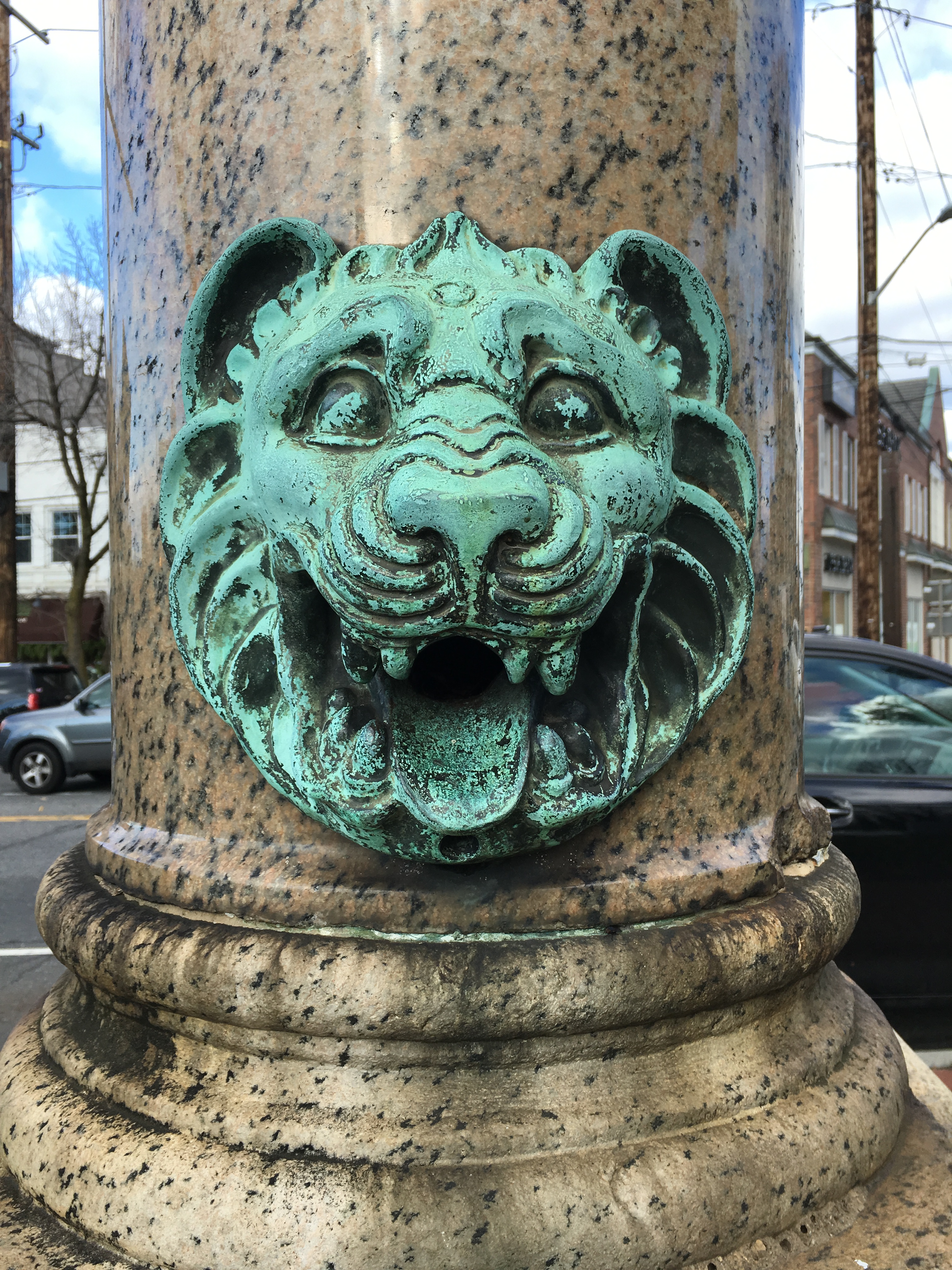 The now dry lion head spout on the south side of the monument.