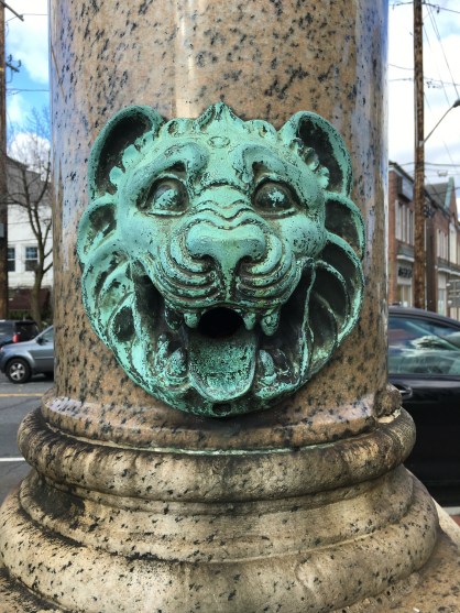 The now dry lion head spout on the south side of the monument.
